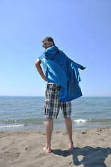 Image showing funny superhero standing on beach