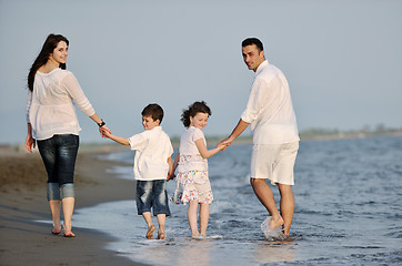 Image showing happy young family have fun on beach