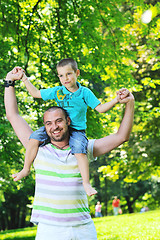 Image showing happy father and son have fun at park