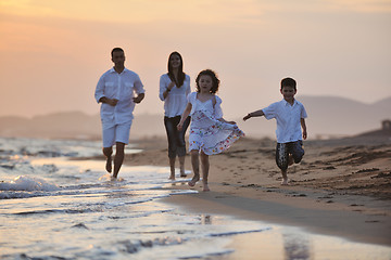 Image showing happy young family have fun on beach