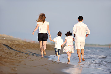 Image showing happy young family have fun on beach