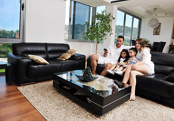 Image showing family wathching flat tv at modern home indoor