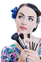 Image showing beautiful young woman applying makeup