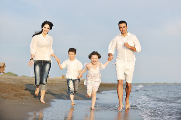 Image showing happy young family have fun on beach at sunset