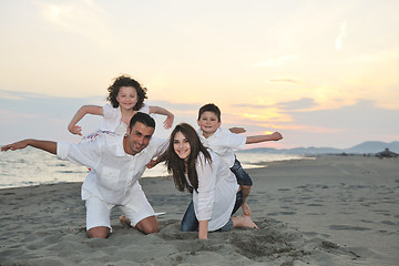 Image showing happy young family have fun on beach