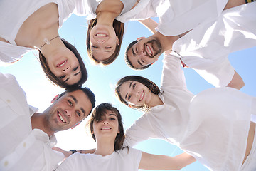 Image showing Group of happy young people in circle at beach