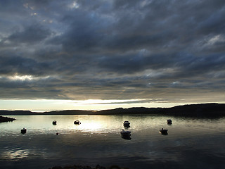 Image showing Sunset over a bay with boats