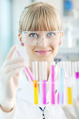 Image showing female researcher holding up a test tube in lab