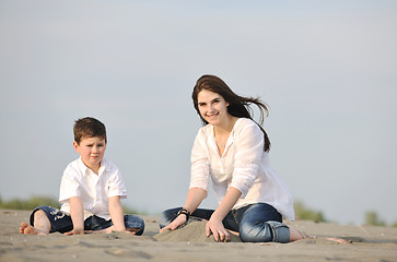 Image showing mom and son relaxing on beach