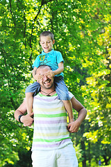 Image showing happy father and son have fun at park