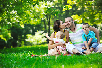 Image showing happy young couple with their children have fun at park