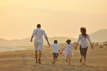 Image showing happy young family have fun on beach at sunset