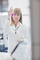 Image showing female researcher holding up a test tube in lab