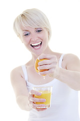 Image showing Young woman squeeze orange juice