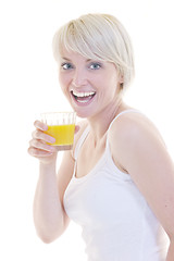 Image showing Young woman drinking orange juice isolated over white background