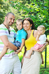 Image showing happy young couple with their children have fun at park