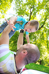 Image showing happy father and son have fun at park