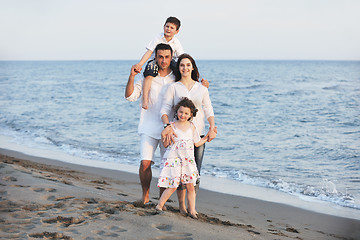 Image showing happy young family have fun on beach