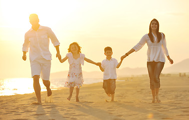 Image showing happy young family have fun on beach at sunset