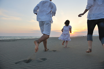 Image showing happy young family have fun on beach at sunset