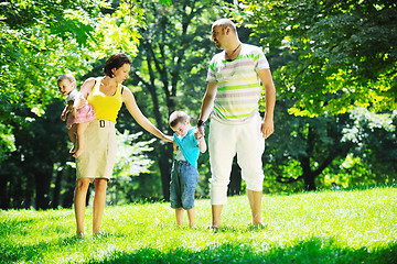 Image showing happy young couple with their children have fun at park