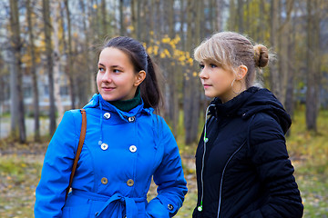 Image showing Two girls walking in the autumn park