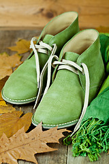 Image showing  leather boots, scarf and yellow leaves