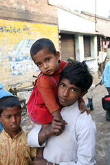 Image showing Alindra Jana, holding his little sister Sabita, at remote village Kumrokhali, West Bengal, India