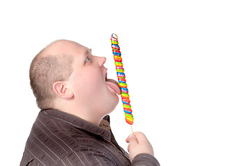 Image showing Fat man enjoying a lollipop