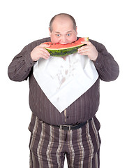 Image showing Obese man eating watermelon