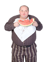 Image showing Obese man eating watermelon