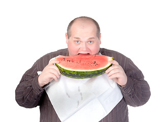 Image showing Obese man eating watermelon