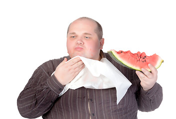 Image showing Obese man eating watermelon