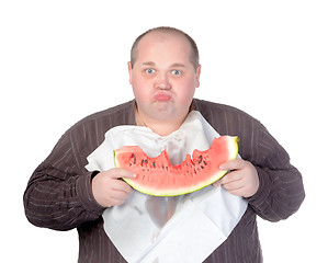 Image showing Obese man eating watermelon