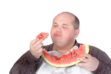 Image showing Fat man savouring a slice of watermelon