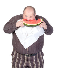 Image showing Obese man eating watermelon