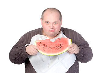 Image showing Obese man eating watermelon