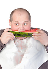 Image showing Obese man eating watermelon