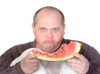 Image showing Obese man possessive of his food