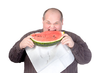 Image showing Obese man eating watermelon