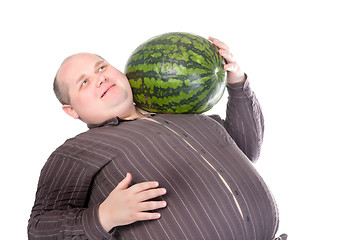 Image showing Obese man carrying a watermelon