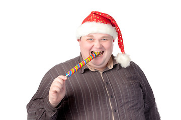 Image showing Cheerful fat man in Santa hat