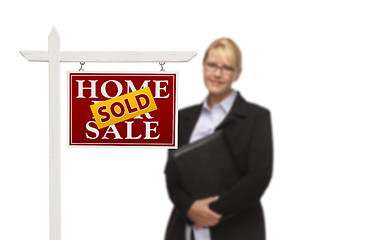 Image showing Businesswoman Behind Sold Home For Sale Real Estate Sign Isolate