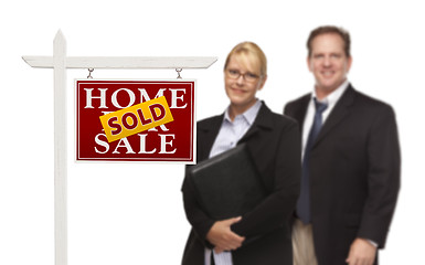 Image showing Businesswoman and Businessman Behind Real Estate Sign Isolated