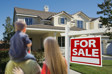 Image showing Family Looking at New Home with For Sale Sign 