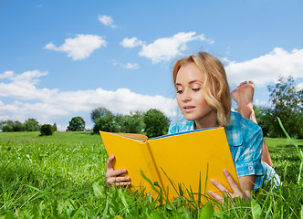 Image showing pretty woman laying on lawn