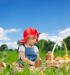 Image showing child sitting with picnic basket