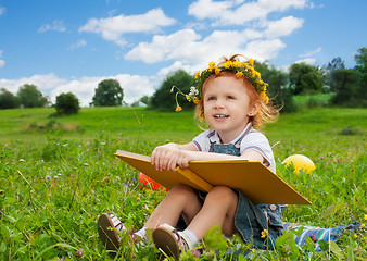 Image showing cute girl smiling holding book