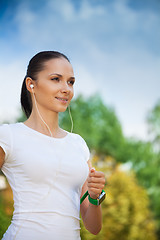 Image showing young positive jogger in park