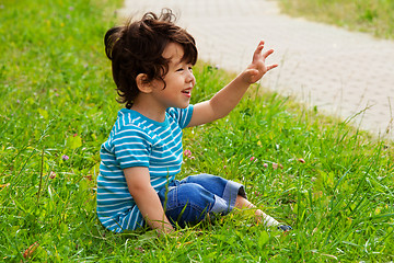 Image showing little boy sitting and waving